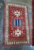 Red ground Eastern rug with blue ground rectangular central medallion, flanked by cream ground