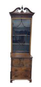 19th century cabinet of narrow form, the broken carved swan-neck pediment with fretwork carving,