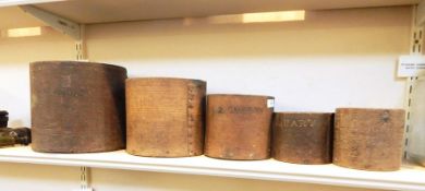 Set of five graduated early 20th century treen bushel measures, each stamped 'City of Gloucester',