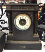 Two black slate mantel clocks, one with Roman numerals to the white enamel dial, the other of