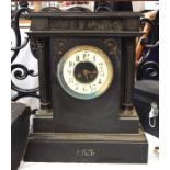 Two black slate mantel clocks, one with Roman numerals to the white enamel dial, the other of