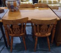 Pine kitchen/dining table on turned supports and four pine railback dining chairs