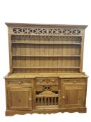 20th century pine dresser with moulded pediment above three shelves, on a base of assorted