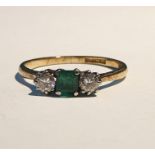 Gold three-stone diamond and emerald ring, the central square cut emerald flanked by two brilliant