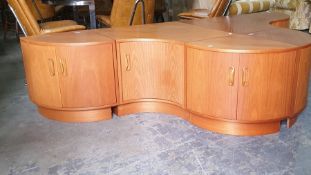 G-Plan teak sectional low lounge unit consisting of serpentine-fronted cupboards