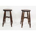 Pair of elm circular stools on four turned supports united by cross stretchers, 55cm high