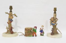 Pair of Goebel pottery lamp bases modelled as children being chased up trees by dogs, each 30.5cm