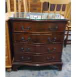 Reproduction mahogany serpentine fronted chest of four long drawers with fluted canted corners on