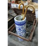 Large ceramic blue and white Chinese style umbrella stand/stick stand containing a walking stick and