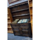 20th century oak dresser with two shelves above a base of two drawers and two cupboard doors, 106.