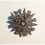 Gold-coloured metal and diamond star-pattern brooc