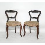 Four mahogany balloon back chairs with carved top rail and bar back, serpentine fronted, overstuffed