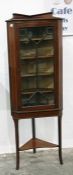 Edwardian inlaid mahogany corner cupboard having four shelves enclosed by astragal glazed door,