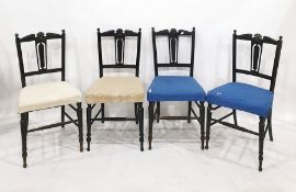 Set of four Victorian ebonised chairs with carved and pierced back splats above upholstered seats (