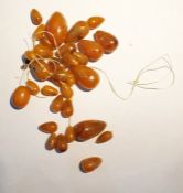 Quantity of amber graduated oval beads, unstrung, approx 40g