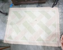 Cream ground rug with pale pink and green lattice decoration, 151cm x 111cm