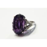 18ct white gold, amethyst and diamond dress ring set one large facet cut amethyst, approx 24.7mm x