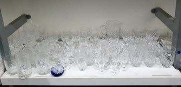 Suite of assorted glassware to include wine glasses, tumblers, water jug, etc and a paperweight