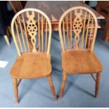 Four beech framed wheelback dining chairs and a cane-seated bedroom chair (5)