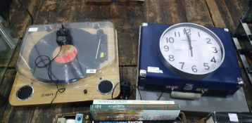 Ion record deck with a long playing record.  A further modern suitcase type record player and two