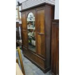 Late 19th/early 20th century wardrobe with single arched top mirror and central drawer, above two