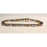14K yellow and white gold and diamond bracelet formed of 16 crescent-shaped links, each set numerous