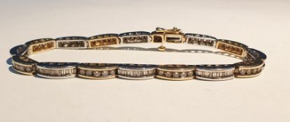 14K yellow and white gold and diamond bracelet formed of 16 crescent-shaped links, each set numerous