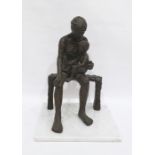 Bronze-effect sculpture of figure with child upon knee, the whole raised on a white marble base,