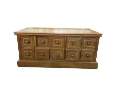 20th century hardwood coffee table with stone inset top, the body with ten double-sided drawers,