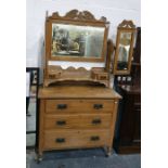 Early 20th century walnut dressing chest, the three-part mirrored superstructure above three