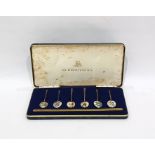 Set of six silver gilt and floral enamel coffee spoons, the bowls with basse taille enamelling of