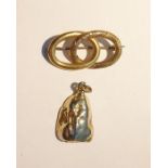 Gold-coloured openwork knot-pattern, cut and polished, yellow metal mounted pendant brooch and a