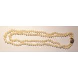 Cultured pearl necklace, twin-strand, slightly graduated and the circular diamond set clasp of