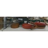 Le Creuset and other makes frying pans and a set of graduated lidded saucepans