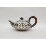 George IV silver teapot by Richard Sibley, London 1825, of squat half-fluted circular form with