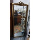 Rectangular two-part wall mirror with ribbon moulding to the pediment, in a gold-coloured frame,