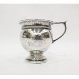 Arts & Crafts silver mug by A E Jones, Birmingham 1925, of bulbous hammered form with wire twist