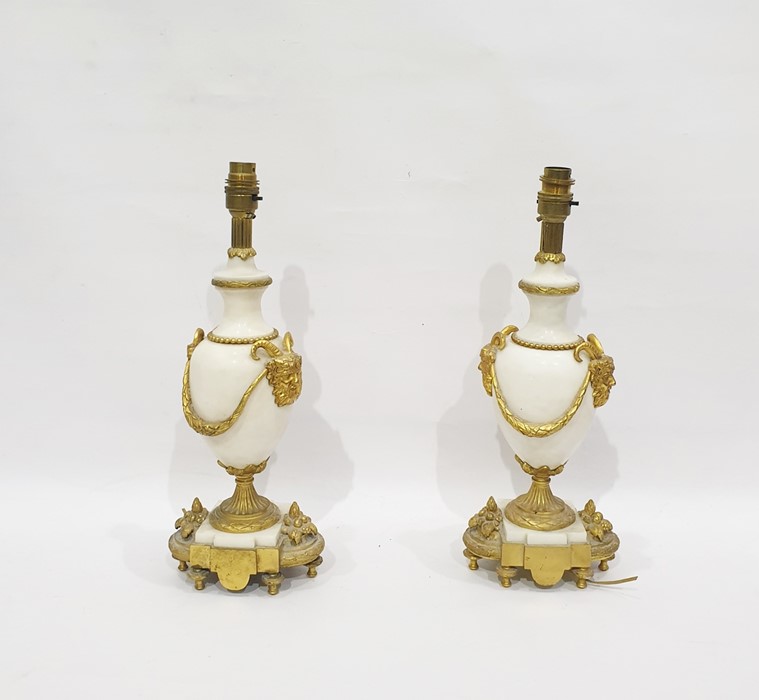 Pair of gilt brass and polished white stone table lamps, the turned bodies with brass faun head