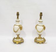 Pair of gilt brass and polished white stone table lamps, the turned bodies with brass faun head