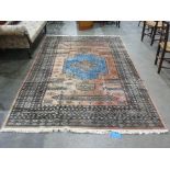 Salmon ground rug with stepped fawn and sky blue central medallion, assorted floral motifs to a