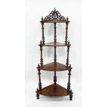 Victorian walnut four-tier waterfall whatnot with turned columns uniting the tiers, 139cm