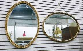 Two 20th century oval bevel edged gilt framed wall mirrors (2)