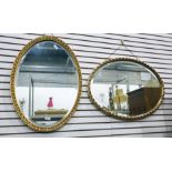 Two 20th century oval bevel edged gilt framed wall mirrors (2)