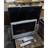 Sony Bravia flatscreen television and another smaller flatscreen television with remote controls