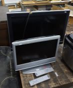 Sony Bravia flatscreen television and another smaller flatscreen television with remote controls