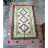 Cream ground rug with three central medallions in pinks, blues, browns, yellows and greens, 182cm