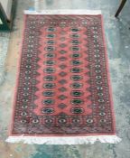 Eastern pink green rug with 24 central elephant foot gul medallions, on a stepped border, 145cm x