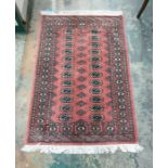 Eastern pink green rug with 24 central elephant foot gul medallions, on a stepped border, 145cm x