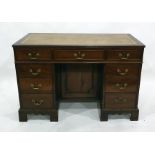 20th century mahogany desk with brown leatherette inset top above the seven assorted drawers, raised