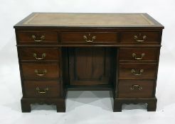 20th century mahogany desk with brown leatherette inset top above the seven assorted drawers, raised